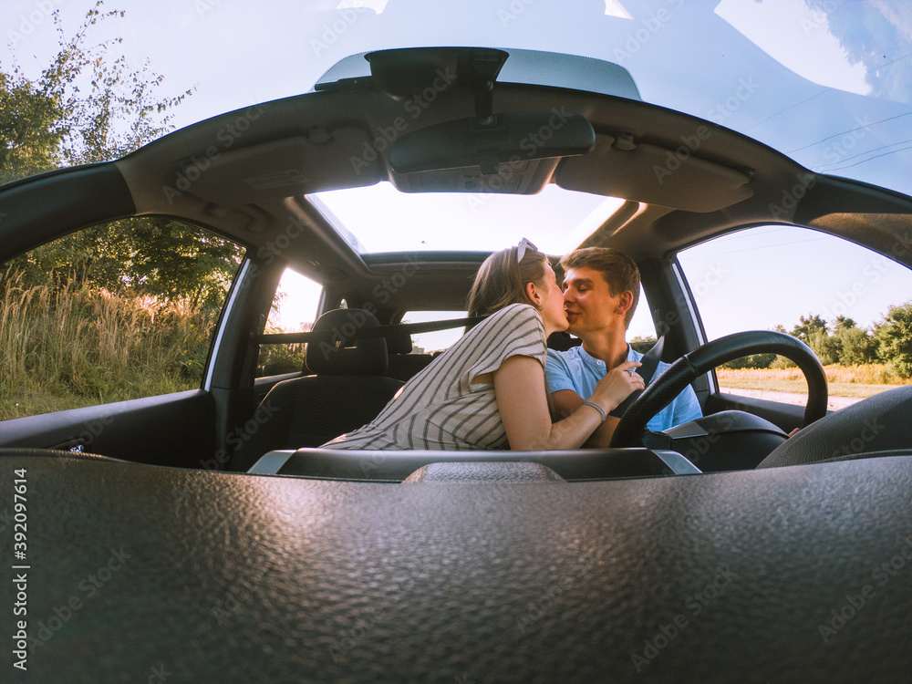 Fototapeta premium young happy couple in car