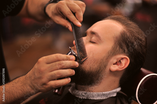 Brutal barber shaves a man in a barbershop