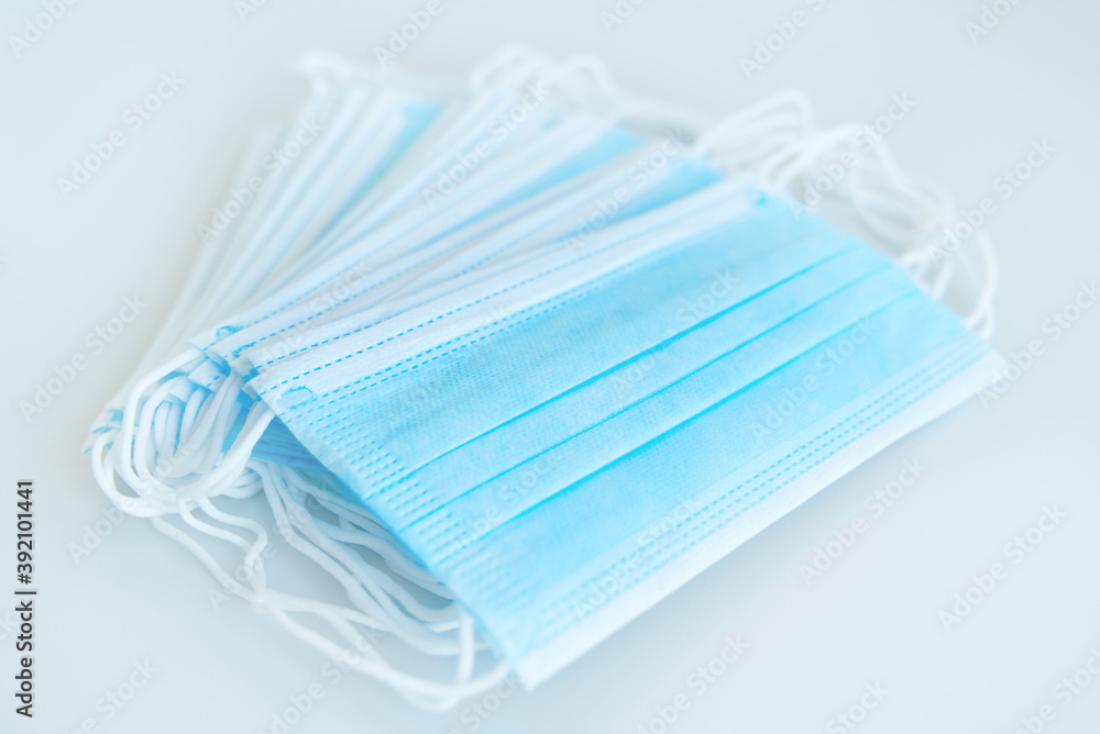 Surgical mask with rubber ear straps. Protective mask from bacteria and virus infection. Coronavirus protection concept. Surgical mask with rubber ear straps. Protective mask from bacteria and virus infection. Coronavirus protection concept.