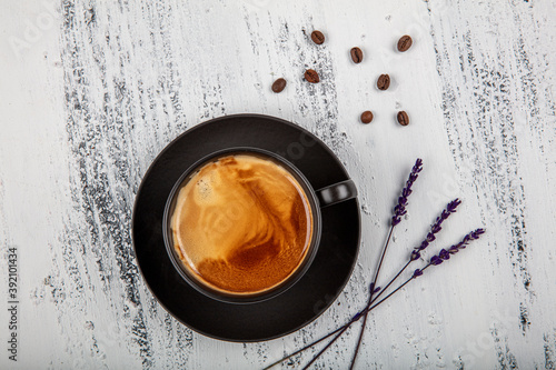 Double espresso. Close up espresso glass cup with coffee bean, on old wooden table photo