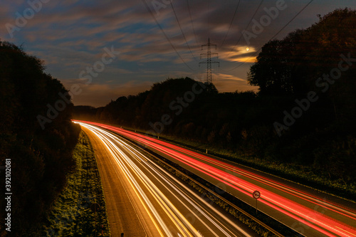 Fototapeta Beautiful and colorful long exposure of the driving cars on the highway at night