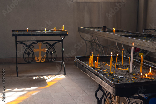 Lighted candles inside of the Holy Savior Cathedral (Ghazanchetsots Cathedral) in the Artsakh city Shusha or Shushi photo