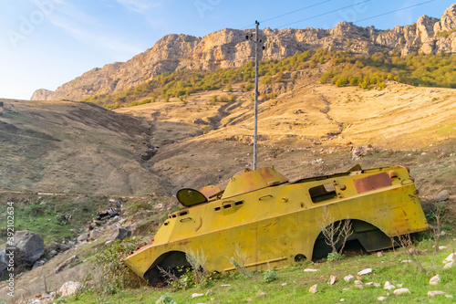Side of an abandoned war tank with vegetation growing inside close to Shushi in the Republic of Arstakh in Nagorno Karabakh photo