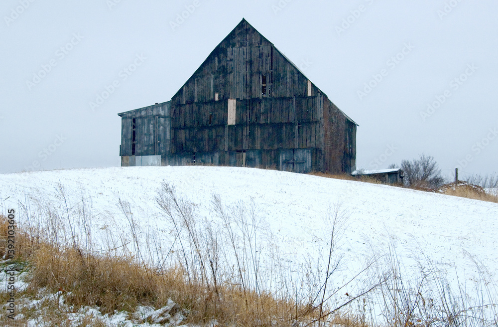 An unpainted barn in a snowstorm, outside Westin, MO. An unpainted barn in a snowstorm, outside Westin, MO.
