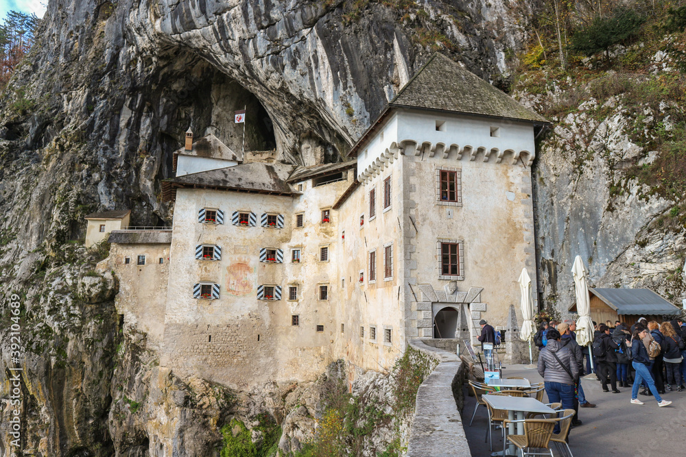 Predjama/ Slovenia-October 11th, 2018: Magnificent stone castle built in front of the cave entrance, shielded by steep, inapproachable cliff
