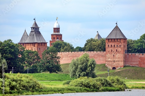 Old fortress with towers in the forest on the river bank