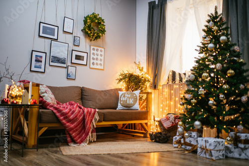 new year cozy home interior with christmas tree and garlands