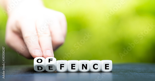 Fotografering Dice form the words offence and defence.