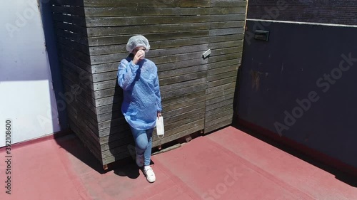 Young nurse having a coffee break at work after an exhaustive day