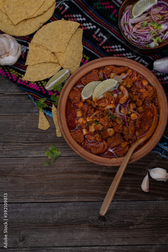 Vegan pozole rojo made with seitan, served in traditional mexican bowl , copy space