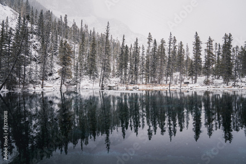 Alpine Lake With Fresh Snowfall and Glassy Reflections 