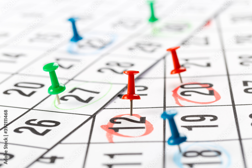 Thumbtack in calendar concept for busy, appointments and meeting reminders Thumbtack in calendar concept for busy, appointments and meeting reminders