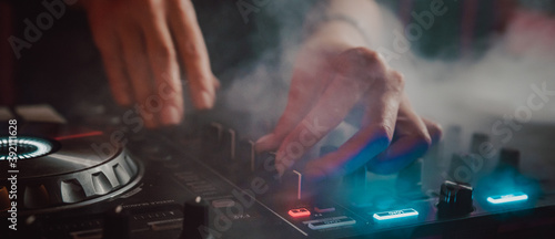 Obraz na plátně DJ Hands creating and regulating music on dj console mixer in concert nightclub