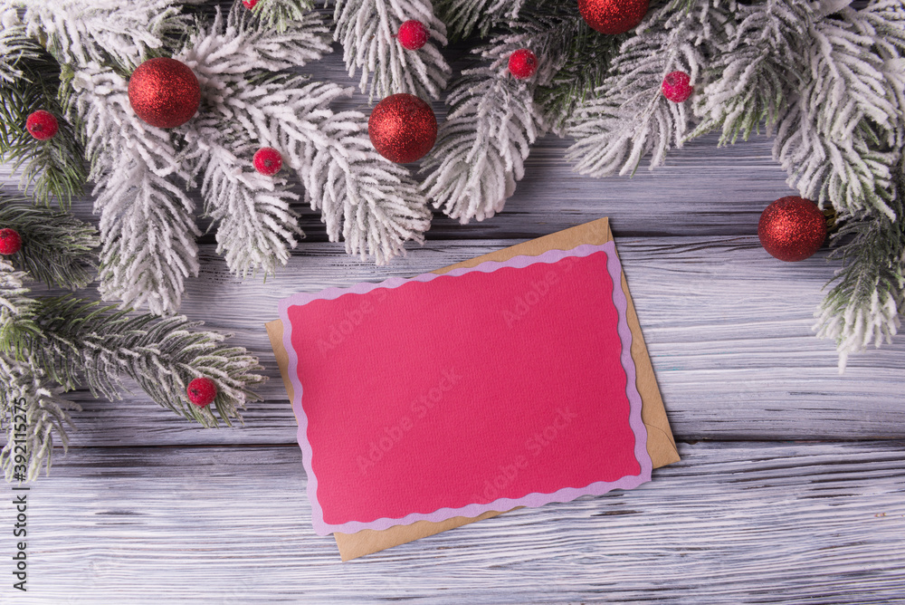 Fototapeta premium Blank red card with envelope and Christmas decoration. Xmas and New Year greeting