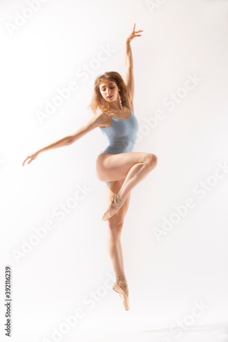 Wallpaper Mural Ballerina in light blue leotard dancing against a white background. Torontodigital.ca