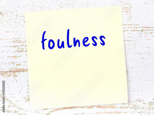 Yellow sheet of paper with word foulness. Reminder concept photo