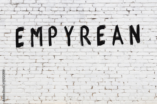Fotografie White wall with black paint inscription empyrean on it