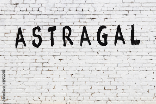 Inscription astragal painted on white brick wall