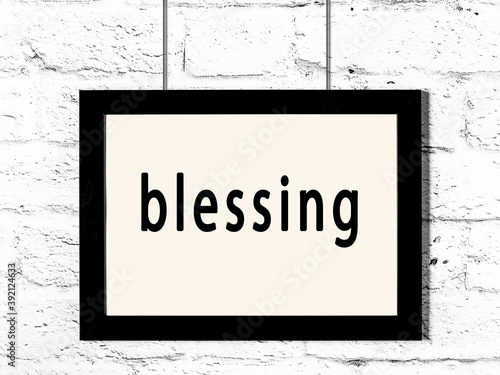Foto Black frame hanging on white brick wall with inscription blessing