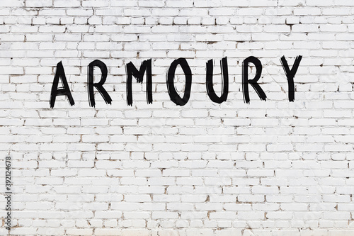 Inscription armoury painted on white brick wall
