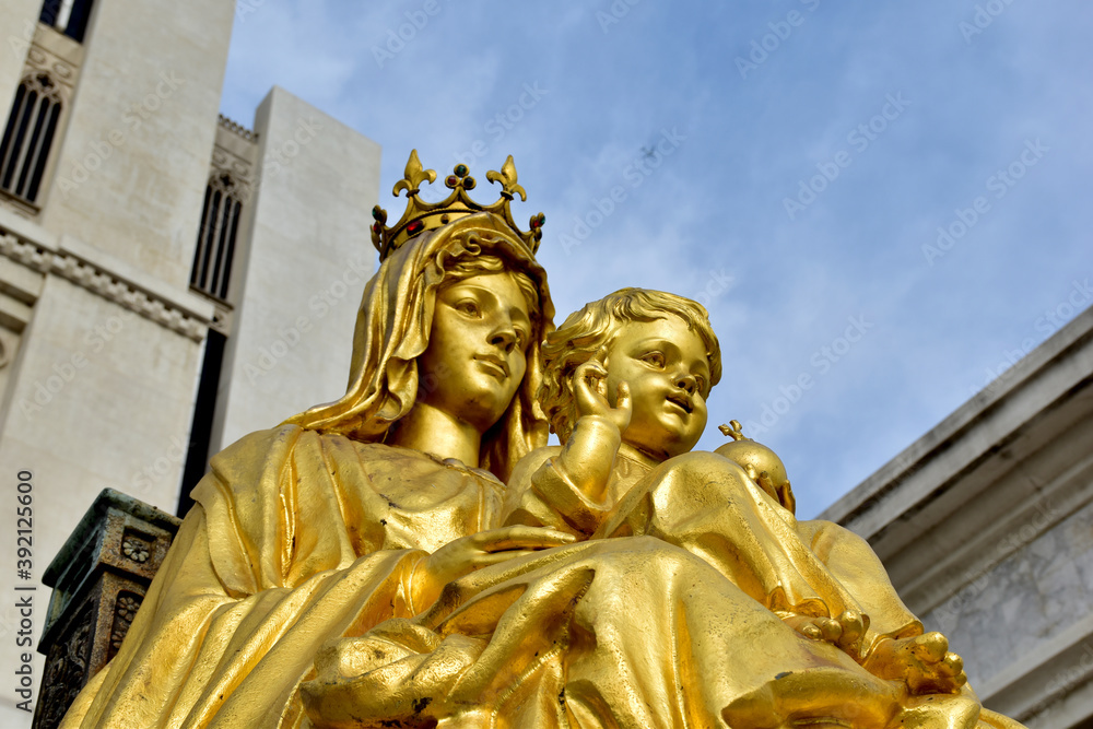 Statue gold Our Lady of Grace Virgin Mary with Child Jesus in the church, Thailand. selective focus.