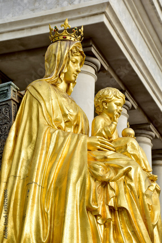 Statue gold Our Lady of Grace Virgin Mary with Child Jesus in the church, Thailand. selective focus.