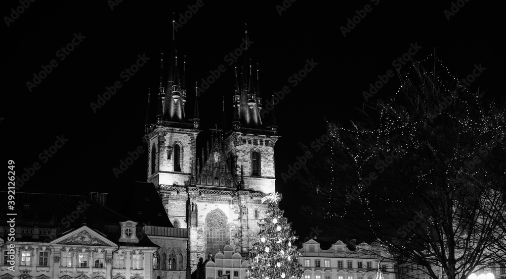 Cathedral towers and Christmas tree decorated by lights and comete, in Old Town Prague, Advent pediod