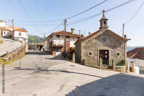 a street in Vila Marim town and the Chapel of the Martyr Saint Sebastian, municipality of Mesao Frio, Vila Real district, Douro, Portugal photo