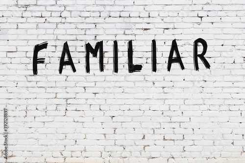 White wall with black paint inscription familiar on it