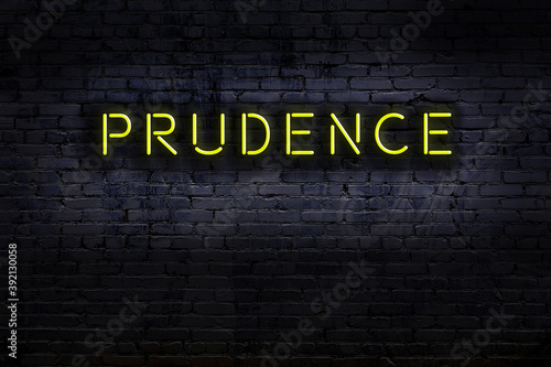 Bild auf Leinwand Neon sign. Word prudence against brick wall. Night view
