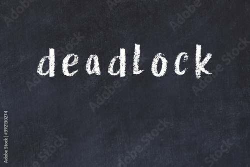 Black chalkboard with inscription deadlock on in