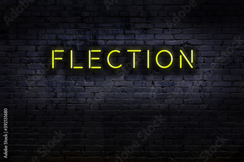 Night view of neon sign on brick wall with inscription flection