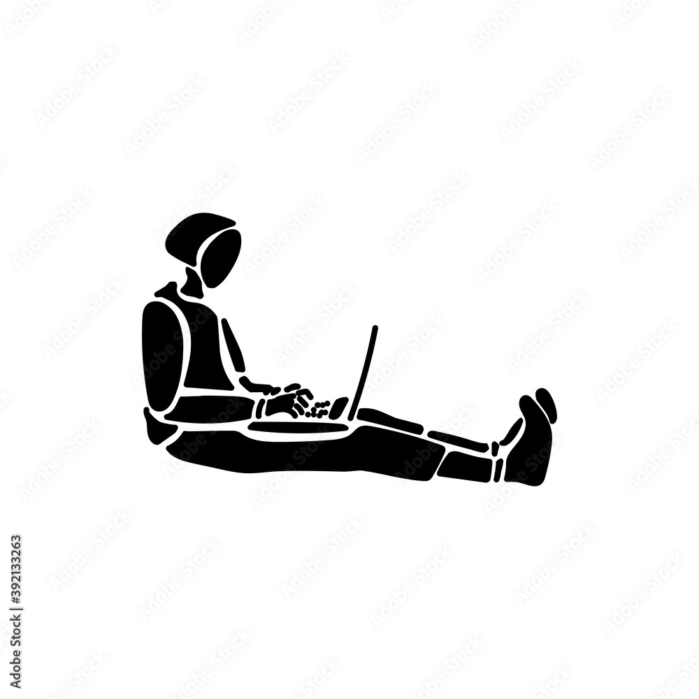 Work at home. Silhouette of a man sitting on the floor and working at a laptop