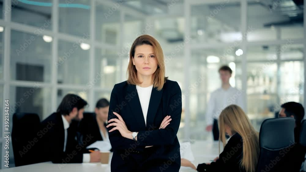 Close up portrait of young attractive blonde businesswoman looking at camera in office workspace background. Concept of work , business, it industry Close up portrait of young attractive blonde businesswoman looking at camera in office workspace background. Concept of work , business, it industry