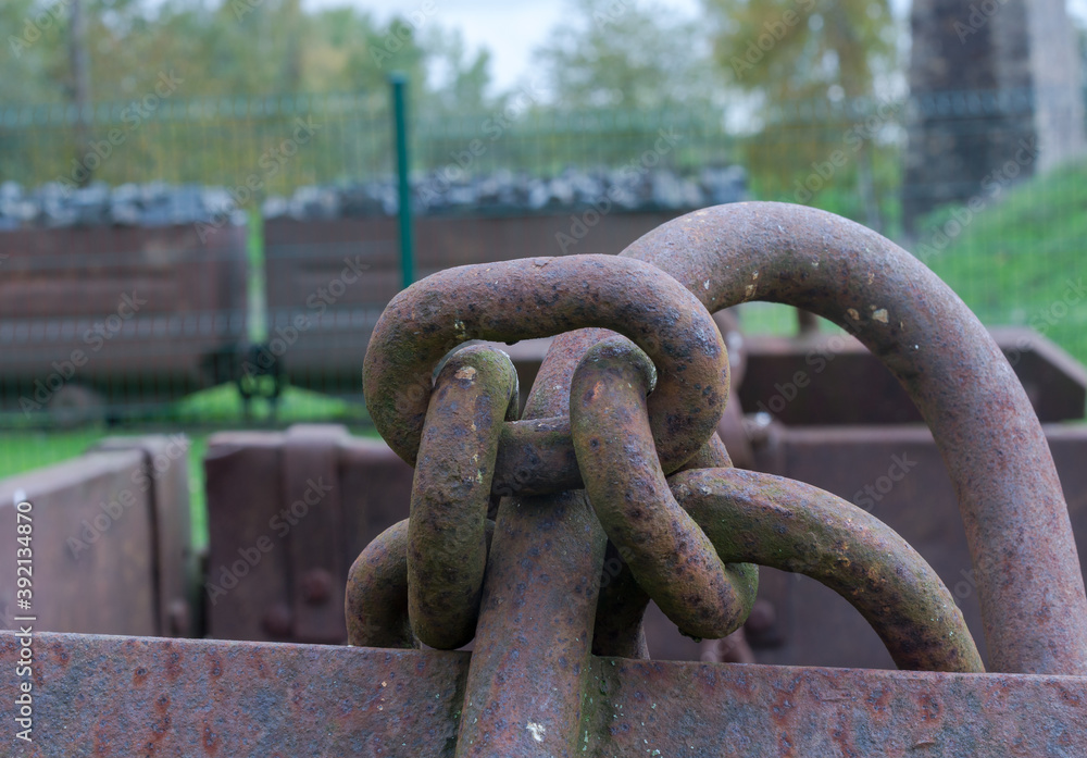 Heavy chain, rusting in time on abandoned ore cart. Heavy chain, rusting in time on abandoned ore cart.