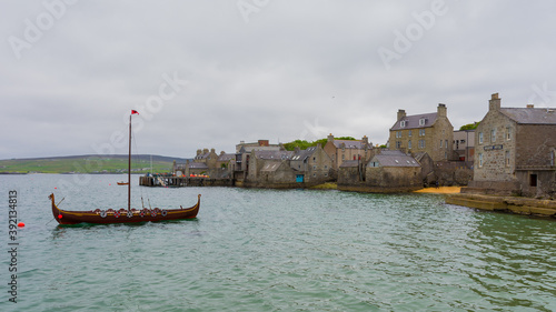 Shetland Islands -  typical Victorian architecture in the port of Lerwick  and a festival viking boat © Octavian