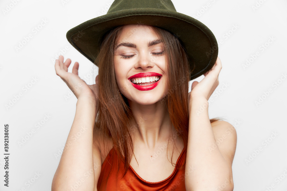 Woman with a hat Keeps hands near the face smile closed eyes on her head model Woman with a hat Keeps hands near the face smile closed eyes on her head model