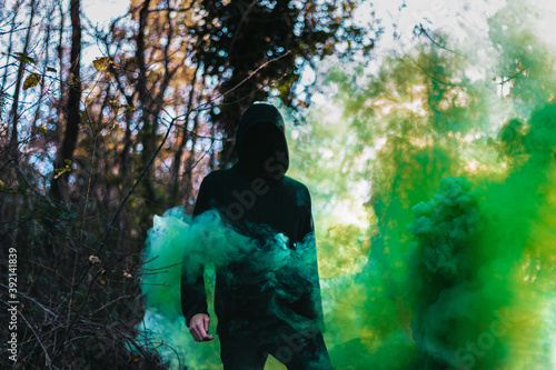 Black figure with green smoke