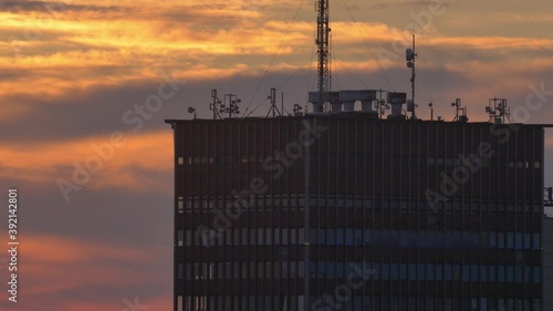 Multiple Broadcasting Antennas on top of High Rise Building at Sunrise