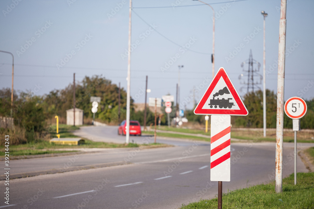 Typical European railroad crossing sign on a rural road indicating an unguarded level crossing Typical European railroad crossing sign on a rural road indicating an unguarded level crossing