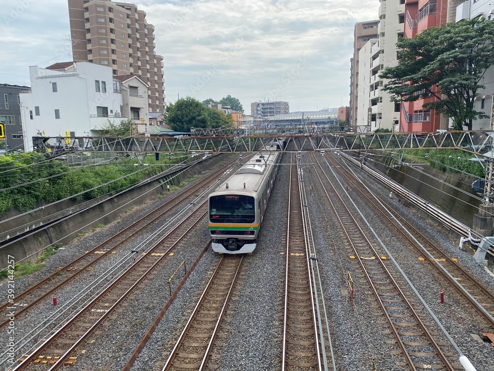 Naklejka premium Six railroad tracks and a train vehicle of East Japan Railway Company taken in Saitama City, Saitama Prefecture, Japan.