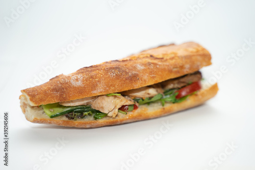 sandwich with ham over a white background. © DAWT_PHOTO