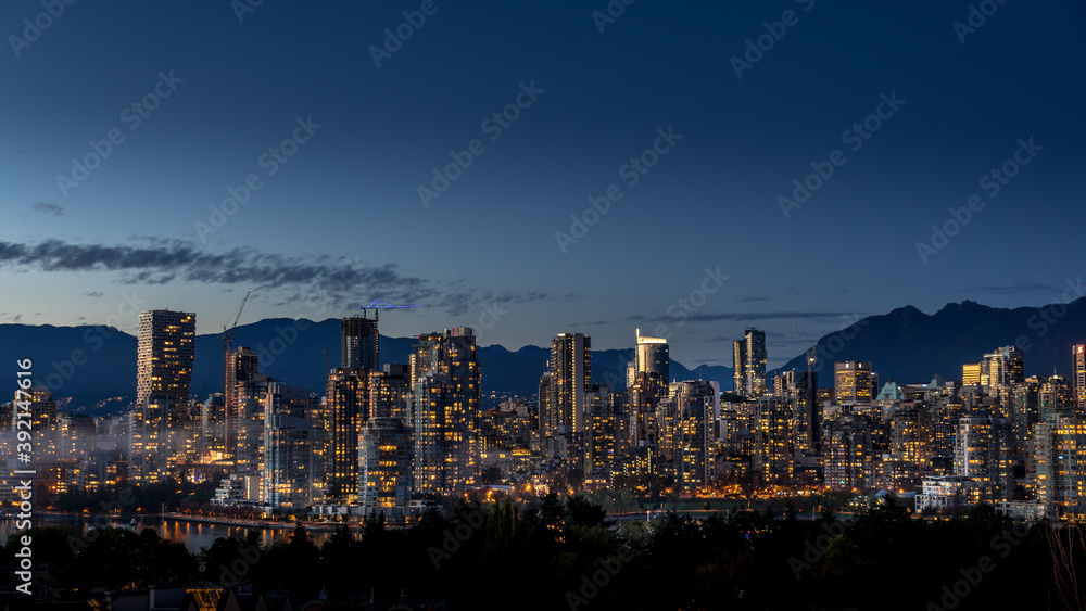 Obraz premium Night Sky of the Skyline of Downtown Vancouver, British Columbia, Canada. Viewed from the South Shore of Falls Creek