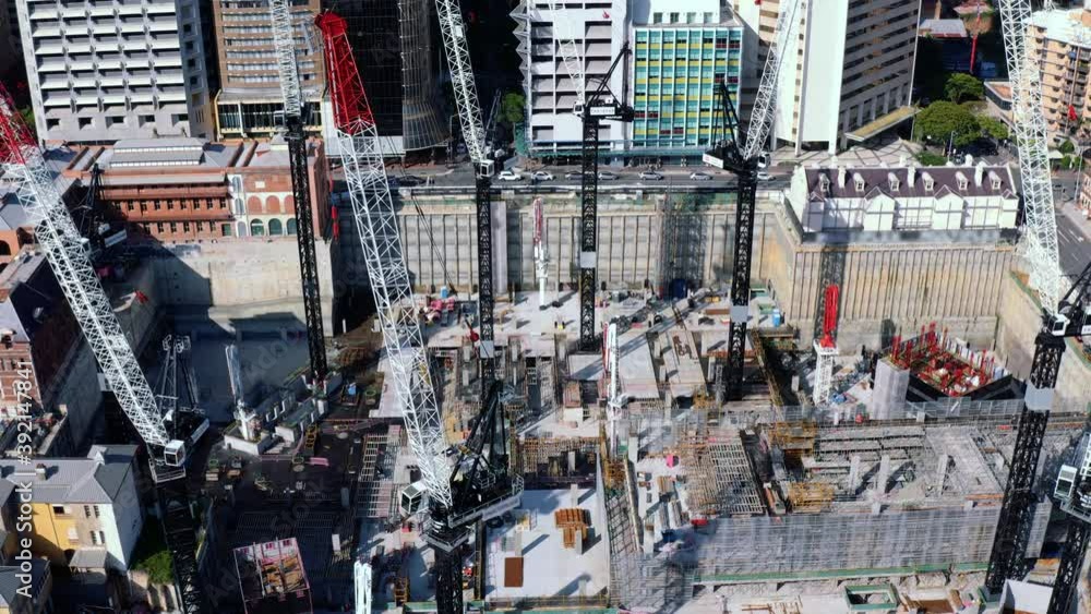Descending aerial view of Queen's Wharf construction site with high cranes in Brisbane CBD, QLD Australia Descending aerial view of Queen's Wharf construction site with high cranes in Brisbane CBD, QLD Australia