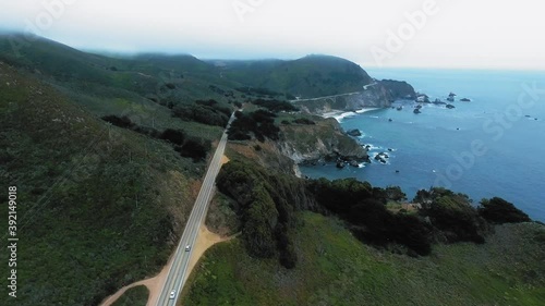 Drone footage of coastal road and misty green hills near the Kasler Point, California, USA photo