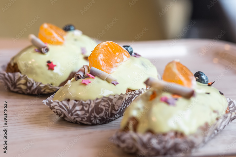 three eclairs with custard in a bakery three eclairs with custard in a bakery