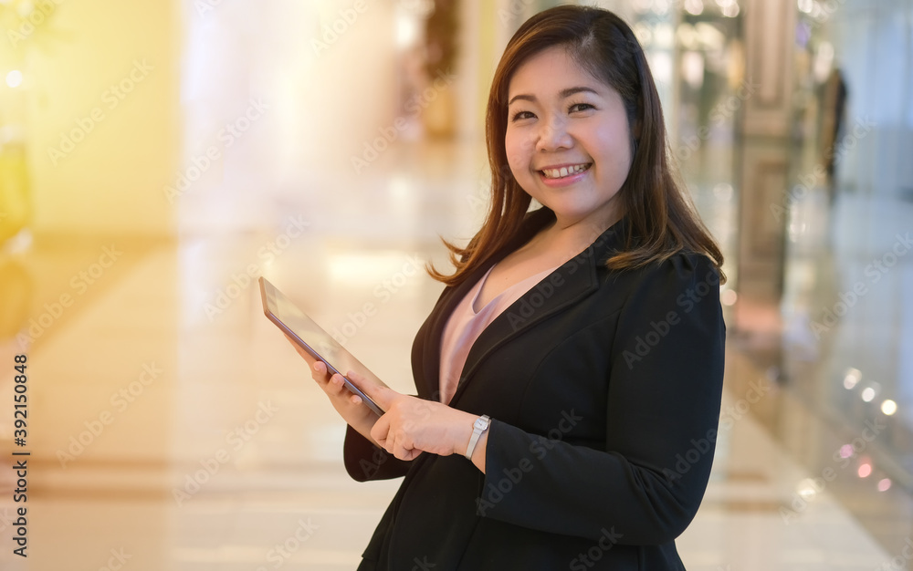 Plus size women pose in feeling happy with tablet, Smile face of beautiful black long hair young Asian overweight woman in black suit. Plus size women pose in feeling happy with tablet, Smile face of beautiful black long hair young Asian overweight woman in black suit.