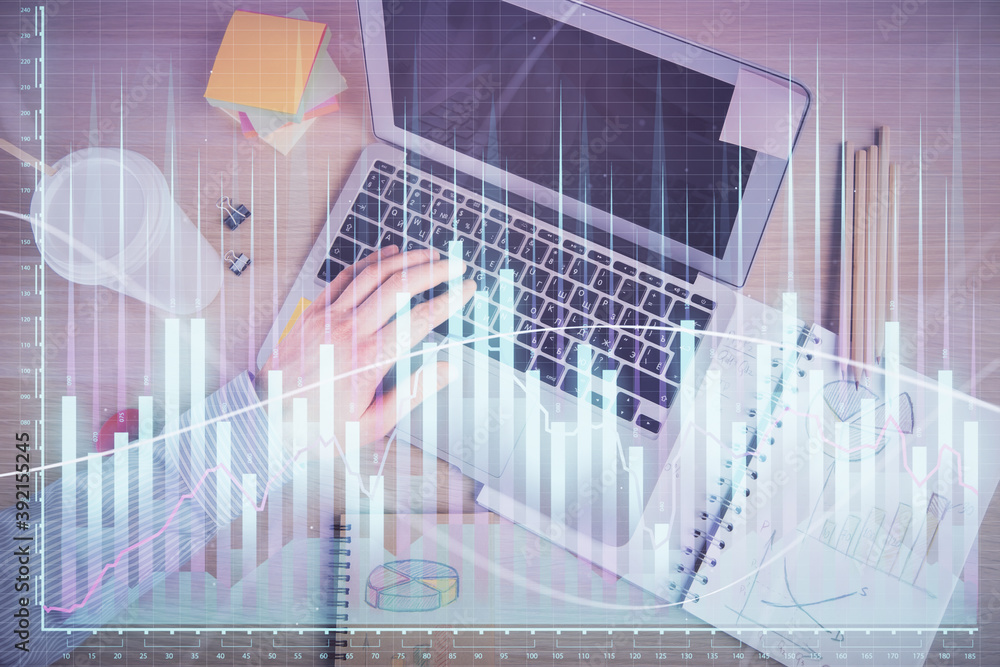 Double exposure of man's hands typing over computer keyboard and forex graph hologram drawing. Top view. Financial markets concept. Double exposure of man's hands typing over computer keyboard and forex graph hologram drawing. Top view. Financial markets concept.