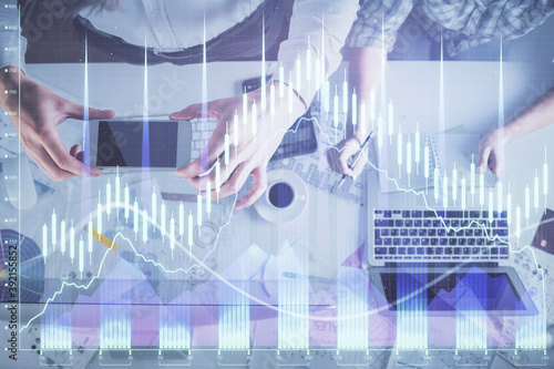 Double exposure of man and woman working together and financial chart hologram drawing. market analysis concept. Computer background. Top View.