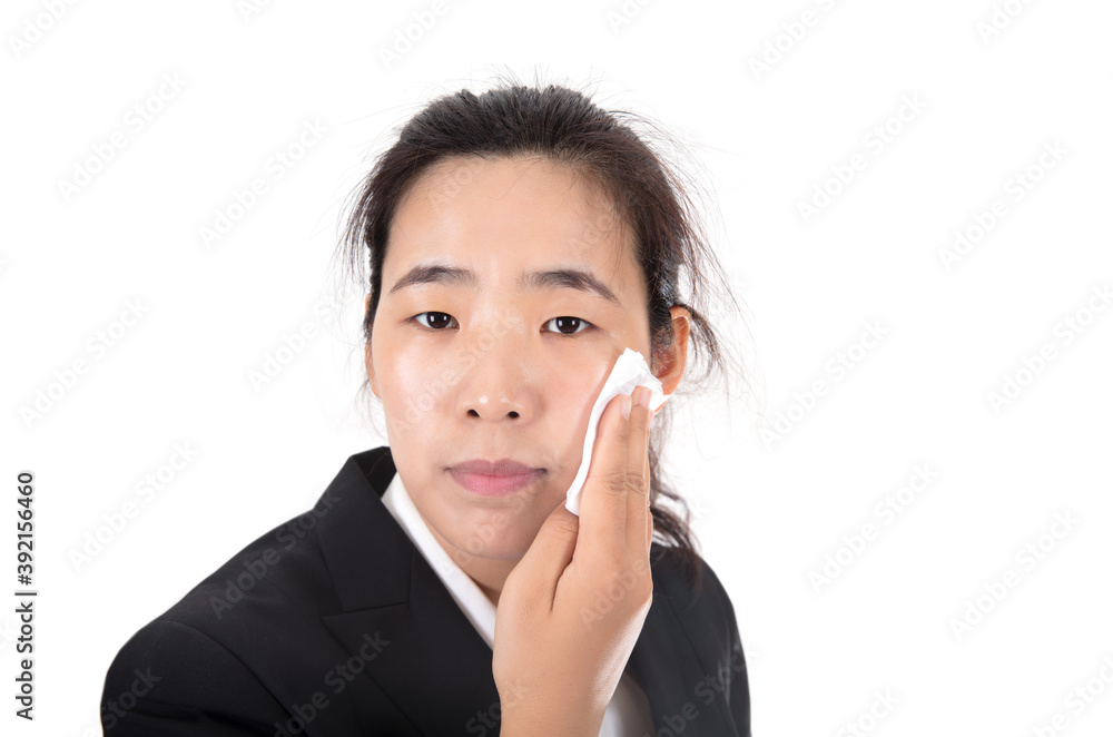 Pretty woman in front of white background is using makeup remover to remove makeup Pretty woman in front of white background is using makeup remover to remove makeup